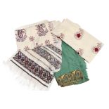 A large silk paisley shawl, a green wool shawl embroidered with floral designs, a cream wool shawl