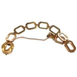A fancy link bracelet, stamped '9CT', length 18.7cm, with an extra link . Gross weight 5.9 grams.