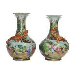 A pair of 19th century Chinese celadon baluster shaped vases, each applied with a moulded mythical