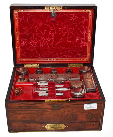 A Victorian rosewood fitted travelling vanity box with an assembled set of silver, silver plate