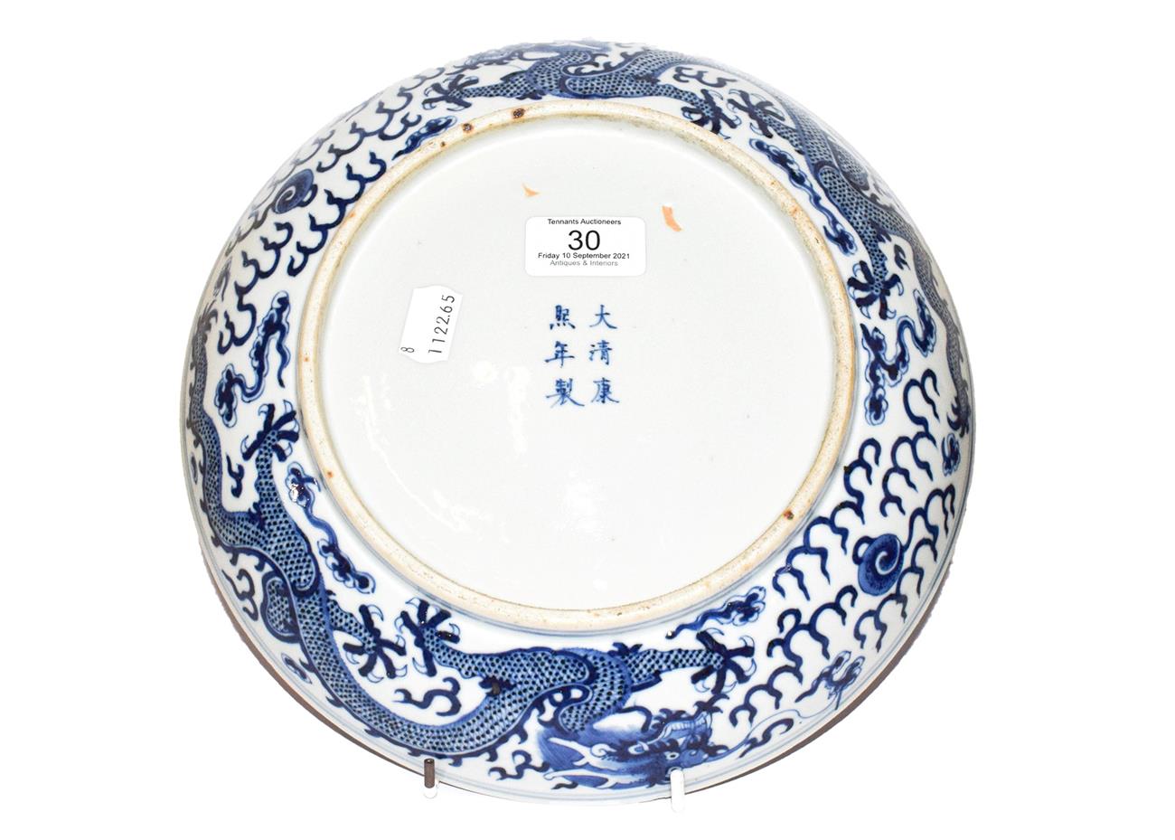 A 19th century Chinese blue and white dish, painted with dragons chasing pearls on grounds of - Image 6 of 8