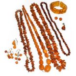 A small quantity of amber and amber type jewellery including four necklaces, a bracelet, three pairs