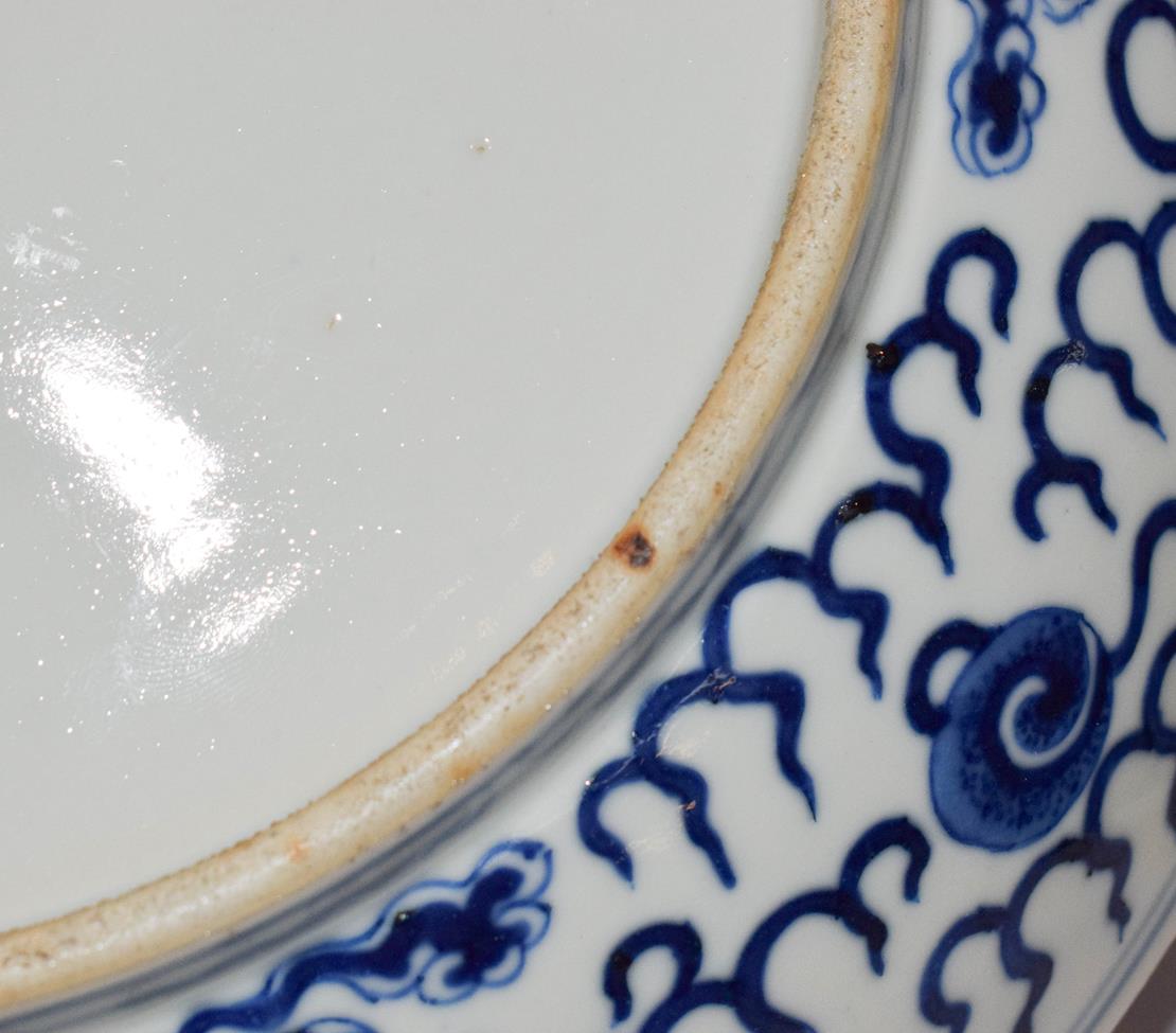 A 19th century Chinese blue and white dish, painted with dragons chasing pearls on grounds of - Image 8 of 8