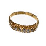 An 18 carat gold diamond five stone ring, the graduated old cut diamonds in yellow claw settings