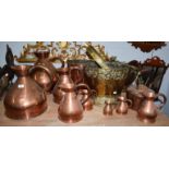 A set of eight 19th century copper measuring jugs, together with an embossed brass coal bucket