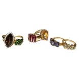 Six 9 carat gold gem set rings, of varying designs and sizes including a smoky quartz example. Gross