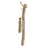 An articulated diamond pendant, length 2.8cm and a section of a diamond bracelet, stamped '14K' (a.