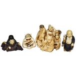 A Japanese Meiji period ivory netsuke in the form of a group of figures, another of a drummer in a