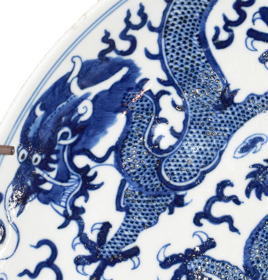 A 19th century Chinese blue and white dish, painted with dragons chasing pearls on grounds of - Image 5 of 8