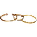 A 9 carat gold baby's bangle, a bangle stamped '375' (a.f.) and a 9 carat gold torque bangle.
