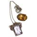 An amethyst pendant on chain, pendant length 4.6cm, chain length 84cm and a citrine brooch, length