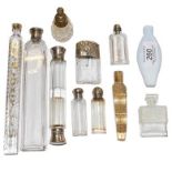 A collection of glass scent bottles including silver topped examples and Lalique