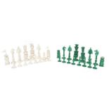 A 19th century Indian ivory chess set, finely carved, the opposing side stained green (complete).