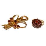 A 9 carat gold garnet brooch, length 4.9cm and a 9 carat gold garnet cluster ring, finger size L.