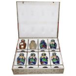 A cased set of eight 20th century Japanese vases portraying the process of cloisonne enameling, with