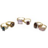 Six 9 carat gold gem set rings, of varying designs and sizes, including a smoky quartz example, a