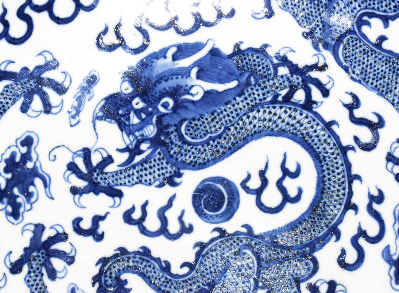 A 19th century Chinese blue and white dish, painted with dragons chasing pearls on grounds of - Image 4 of 8