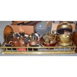 A quantity of antique metal wares including copper cookware, brass fender, candlesticks, coal