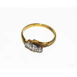 A three stone diamond ring, stamped '18CT' and 'PLAT', finger size P. Gross weight 2.8 grams.