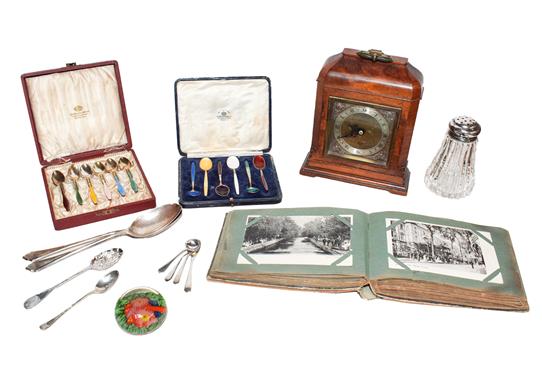 An Elliot mantel timepiece in a burr walnut case, together with a postcard album and contents, a