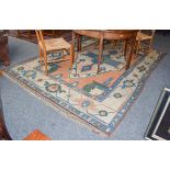 Kozak carpet, the faded terracotta field centred by a sky blue and ivory medallion enclosed by