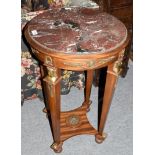 A 20th century French Empire style marble top walnut torchere, with gilt metal mounts on four