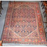 Mahal carpet, the indigo Herati field enclosed by spandrels and borders of angular vines, 372cm by