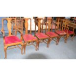 A set of six oak Queen Anne style dining chairs, comprising of a pair of carver armchairs and four