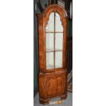 A reproduction walnut standing corner cupboard (a.f.), 58cm by 37cm by 177cm