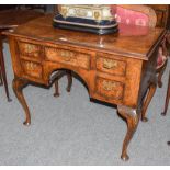 An early 20th century Queen Anne style burr walnut five-drawer low boy, with cabriole supports