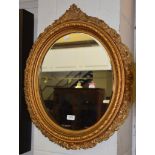 A 19th century gilt framed oval mirror, 57cm by 70cm