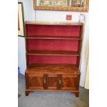 An early 20th century Regency style mahogany waterfall bookcase, with gilt metal gallery and