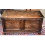 A 20th century carved oak two panel coffer, 90cm by 42cm by 48cm