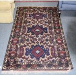 Baluch rug, the field with three medallions enclosed by geometric motif borders, 200cm by 106cm