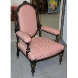 A Victorian ebonised armchair