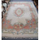 Indian carpet of Savonnerie design, the cream field with central medallion enclosed by spandrels and