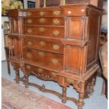 A large 19th century oak chest on stand, with a central column of six graduated drawers flanked by