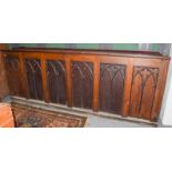 A late 19th century carved oak ecclesiastical vestry cabinet in the Gothic taste, 290cm by 46cm by