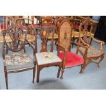 An early 20th century Flemish heavily carved walnut armchair, together with another armchair with