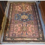 Kuba rug, the field with three stepped medallions enclosed by motif borders, 167cm by 115cm