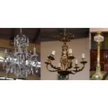 A five branch Rococo style ormolu chandelier, a brass Corinthian oil lamp, and a modern six branch