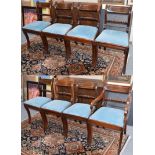 A set of eight Regency dining chairs, with reeded crestings and raised on sabre supports (includes