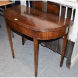 An early 19th century mahogany foldover tea table, with reeded mouldings and raised on square