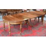 A William IV mahogany D end dining table with three additional leaves, raised on reeded tapering