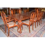 An early 20th century wind out dining table, raised on carved ball and claw supports with two