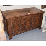 An 18th century oak three panel coffer, carved and with marquetry inlay, 117cm by 49cm by 63cm