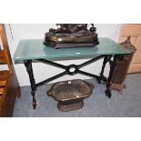 A Victorian painted cast iron table base with a modern glass top, 120cm by 52cm by 75cm