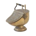 A Victorian Embossed Brass Coal Bucket, late 19th century, with ebonised turned handle and