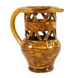 A Halifax Slipware Puzzle Jug, dated 1873, of traditional form with three spouts and pierced neck,