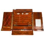 A Late Victorian/Edwardian Walnut Stationery Cabinet, with hinged cresting and two hinged sloping